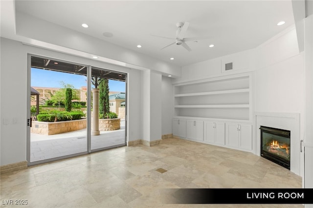 9101 Alta Dr Unit 102, Las Vegas, NV 89145 - unfurnished living room featuring built in shelves, ceiling fan, recessed lighting, baseboards, and a glass covered fireplace