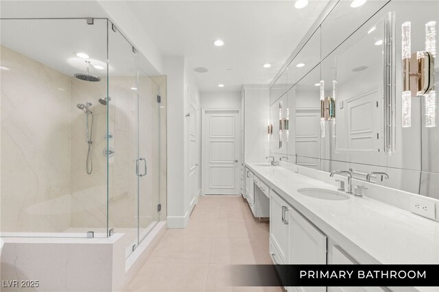 9101 Alta Dr Unit 102, Las Vegas, NV 89145 - bathroom with a marble finish shower, tile patterned floors, recessed lighting, double vanity, and baseboards