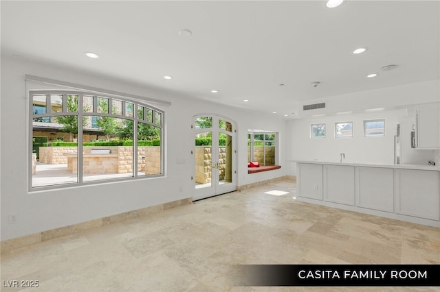 9101 Alta Dr Unit 102, Las Vegas, NV 89145 - unfurnished living room featuring recessed lighting, french doors, a sink, and baseboards