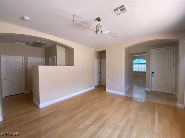 5376 S Conquistador St, Las Vegas, NV 89148 - spare room with arched walkways, baseboards, light wood finished floors, and a smoke detector
