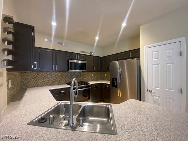 5376 S Conquistador St, Las Vegas, NV 89148 - kitchen with stainless steel appliances, light countertops, decorative backsplash, and a sink