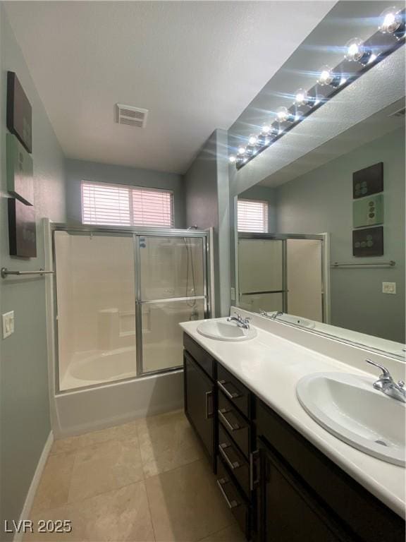 5376 S Conquistador St, Las Vegas, NV 89148 - bathroom with double vanity, shower / bath combination with glass door, tile patterned floors, and baseboards