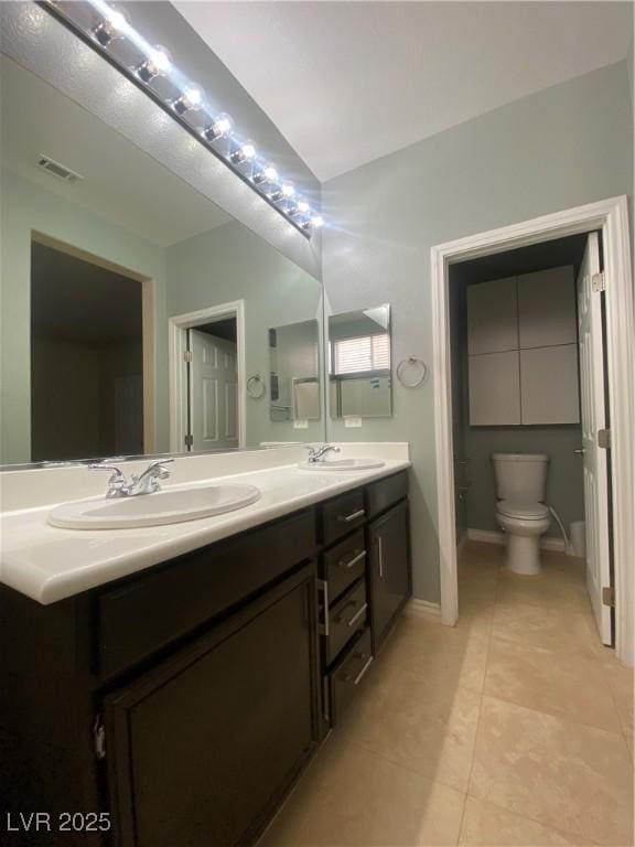 5376 S Conquistador St, Las Vegas, NV 89148 - bathroom with double vanity, toilet, tile patterned floors, and baseboards