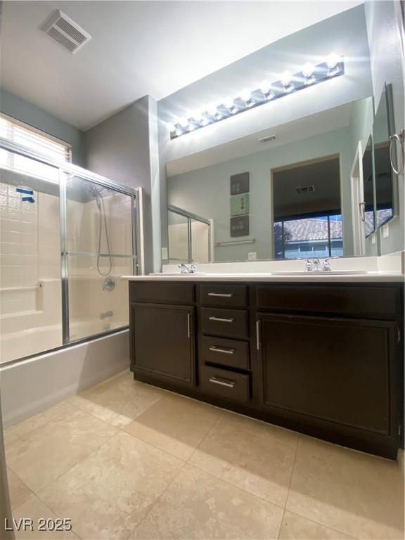 5376 S Conquistador St, Las Vegas, NV 89148 - full bathroom featuring double vanity, bath / shower combo with glass door, and tile patterned floors