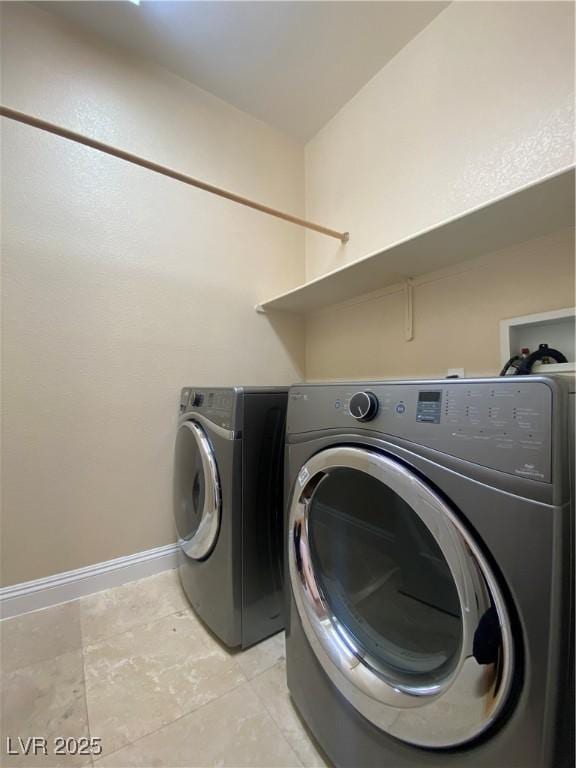 5376 S Conquistador St, Las Vegas, NV 89148 - laundry area featuring separate washer and dryer, baseboards, and light tile patterned floors