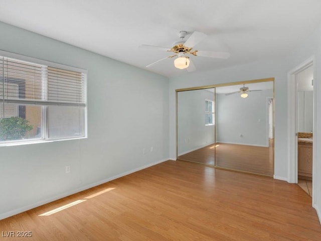 7950 W Flamingo Rd Unit 1077, Las Vegas, NV 89147 - unfurnished bedroom with light wood-style floors, baseboards, a closet, and ceiling fan