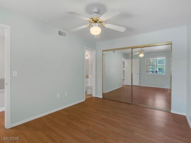 7950 W Flamingo Rd Unit 1077, Las Vegas, NV 89147 - unfurnished bedroom with wood finished floors, a closet, baseboards, ceiling fan, and connected bathroom
