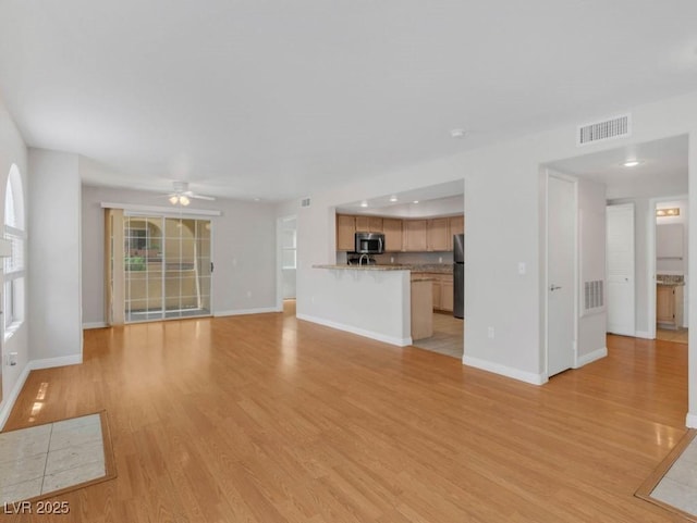 7950 W Flamingo Rd Unit 1077, Las Vegas, NV 89147 - unfurnished living room featuring light wood finished floors, ceiling fan, and baseboards