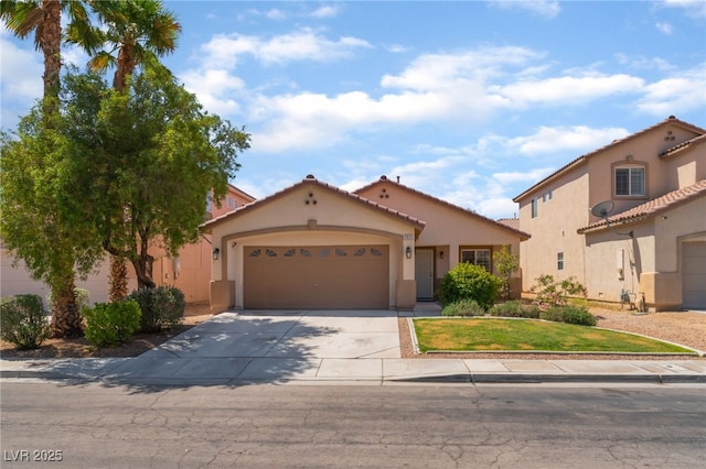 2825 Shayla Bay Ave, North Las Vegas, NV 89086 - mediterranean / spanish house with a garage, concrete driveway, stucco siding, and a tiled roof