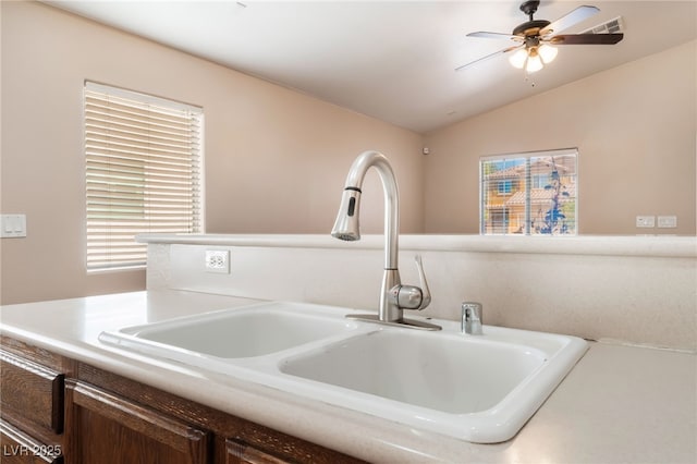 2825 Shayla Bay Ave, North Las Vegas, NV 89086 - detailed view of a sink, a ceiling fan, light countertops, and dark brown cabinets