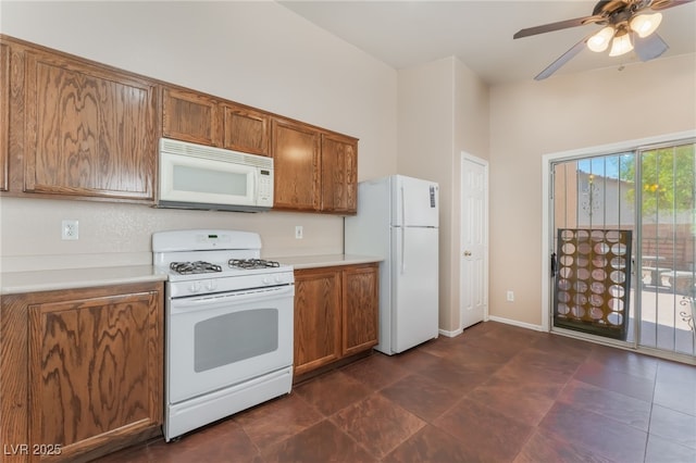 2825 Shayla Bay Ave, North Las Vegas, NV 89086 - kitchen with white appliances, brown cabinets, light countertops, and a ceiling fan