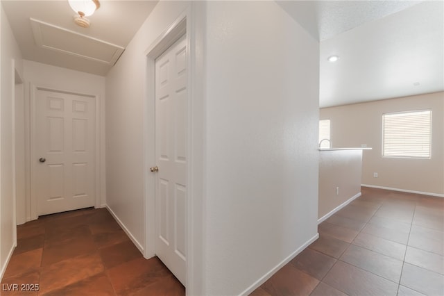 2825 Shayla Bay Ave, North Las Vegas, NV 89086 - hallway featuring attic access, tile patterned flooring, and baseboards