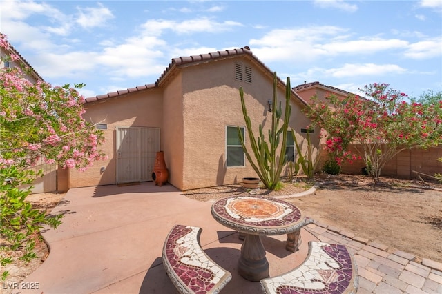 2825 Shayla Bay Ave, North Las Vegas, NV 89086 - rear view of house featuring a patio, stucco siding, and a tile roof