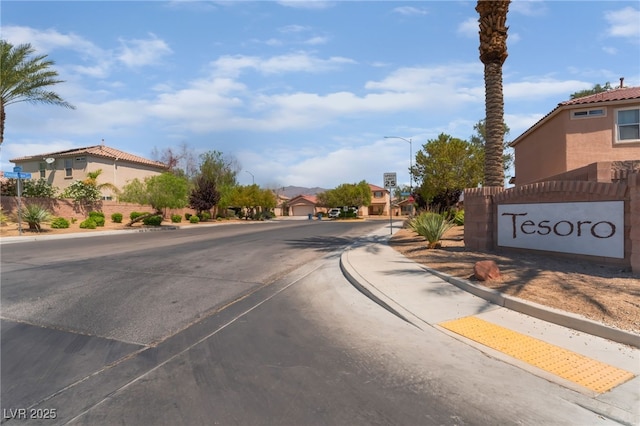 2825 Shayla Bay Ave, North Las Vegas, NV 89086 - view of asphalt street featuring sidewalks, curbs, street lights, and a residential view