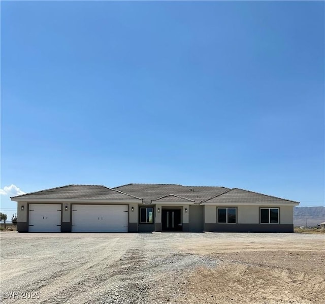 3791 Soplo Rd, Pahrump, NV 89048 - view of front of property with a garage and stucco siding
