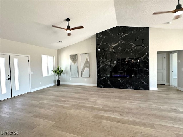 3791 Soplo Rd, Pahrump, NV 89048 - unfurnished living room featuring a ceiling fan, wood finished floors, vaulted ceiling, a textured ceiling, and baseboards