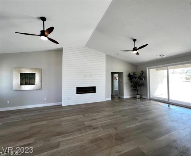 3791 Soplo Rd, Pahrump, NV 89048 - unfurnished living room featuring a ceiling fan, vaulted ceiling, a fireplace, wood finished floors, and baseboards