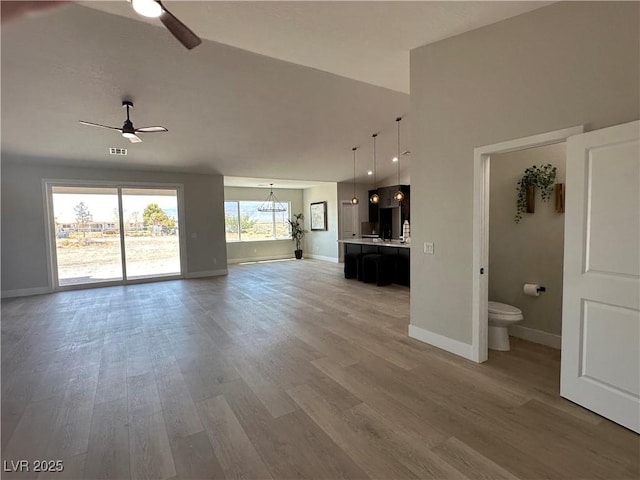 3791 Soplo Rd, Pahrump, NV 89048 - unfurnished living room featuring ceiling fan, baseboards, and light wood-type flooring