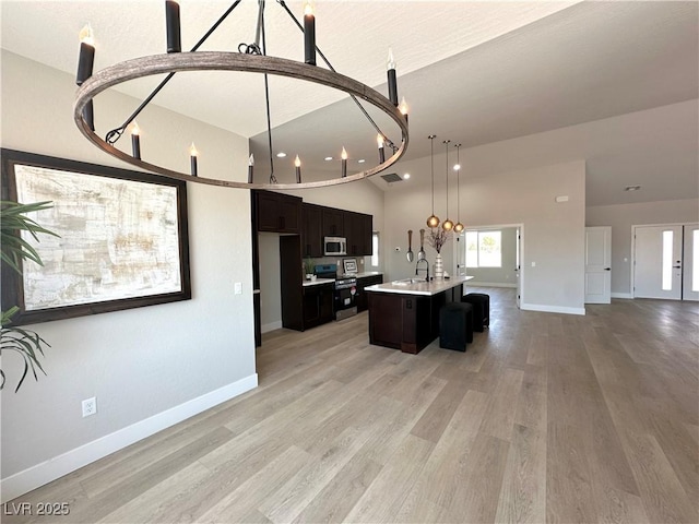 3791 Soplo Rd, Pahrump, NV 89048 - kitchen with appliances with stainless steel finishes, a sink, open floor plan, light countertops, and light wood-style flooring