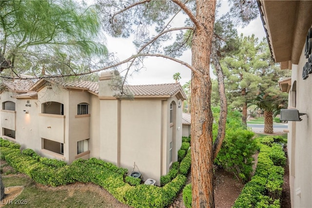 2050 W Warm Springs Rd Unit 4322, Henderson, NV 89014 - view of side of home featuring a tiled roof and stucco siding