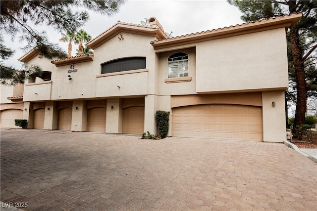 2050 W Warm Springs Rd Unit 4322, Henderson, NV 89014 - view of front of property with decorative driveway, stucco siding, a garage, and a tiled roof