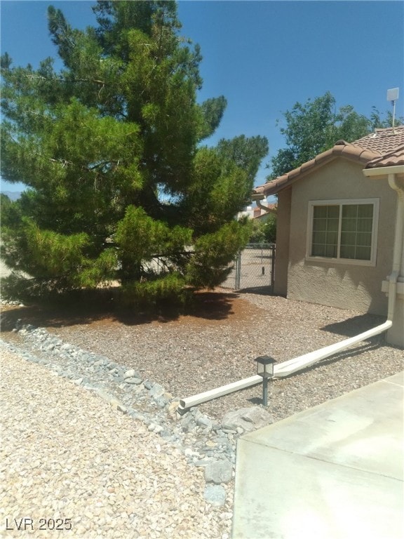 1611 Red Rock Dr, Pahrump, NV 89048 - view of home's exterior featuring stucco siding and a tiled roof