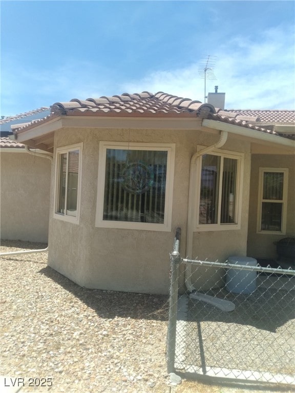1611 Red Rock Dr, Pahrump, NV 89048 - view of property exterior with stucco siding and a tiled roof