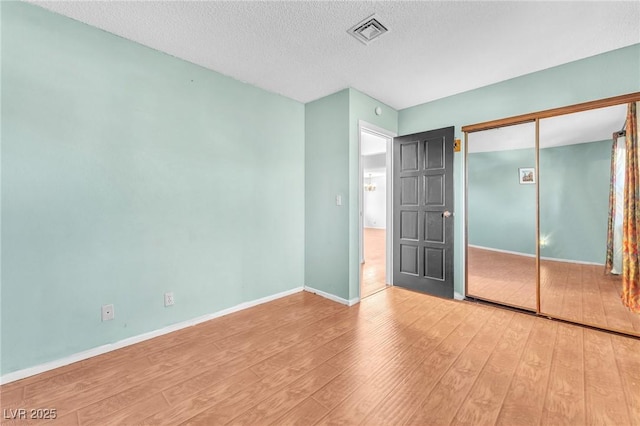 3158 La Luna Cir, Henderson, NV 89014 - unfurnished bedroom featuring wood finished floors, a textured ceiling, and a closet