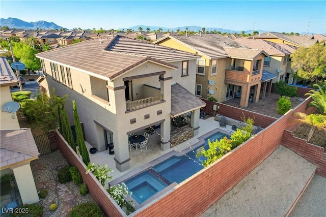 5434 Fawn Chase Way, Las Vegas, NV 89135 - back of house with a balcony, stucco siding, a residential view, a mountain view, and a fenced backyard