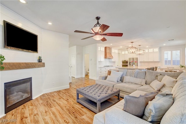 5434 Fawn Chase Way, Las Vegas, NV 89135 - living area featuring ceiling fan, light wood-style flooring, recessed lighting, a large fireplace, and baseboards