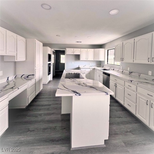 1967 N Moapa Valley Blvd, Logandale, NV 89021 - kitchen with black electric cooktop, stainless steel dishwasher, a kitchen island, white cabinetry, and recessed lighting