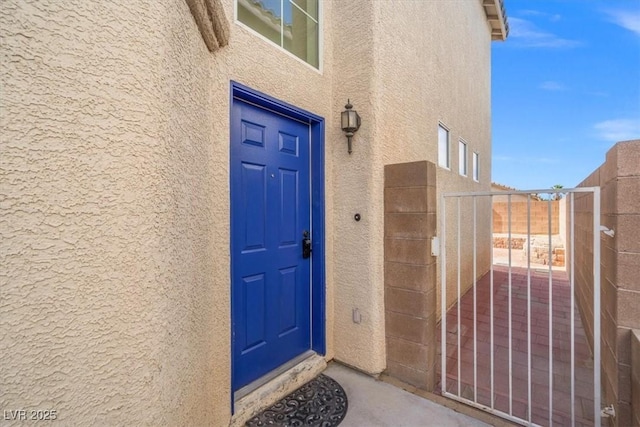 10642 Dawns Mist Ave, Las Vegas, NV 89129 - view of exterior entry featuring stucco siding and a gate