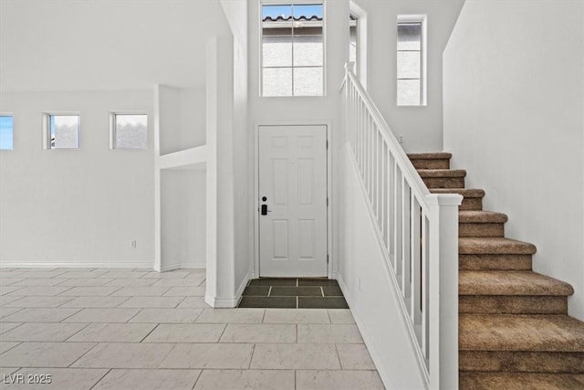 10642 Dawns Mist Ave, Las Vegas, NV 89129 - foyer with healthy amount of natural light, stairs, and baseboards
