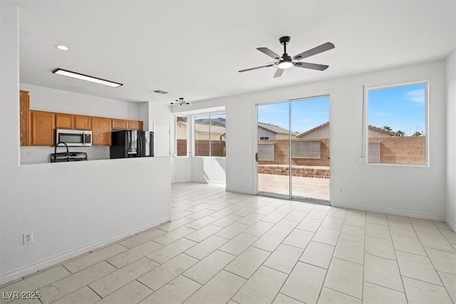 10642 Dawns Mist Ave, Las Vegas, NV 89129 - unfurnished living room featuring a ceiling fan and baseboards