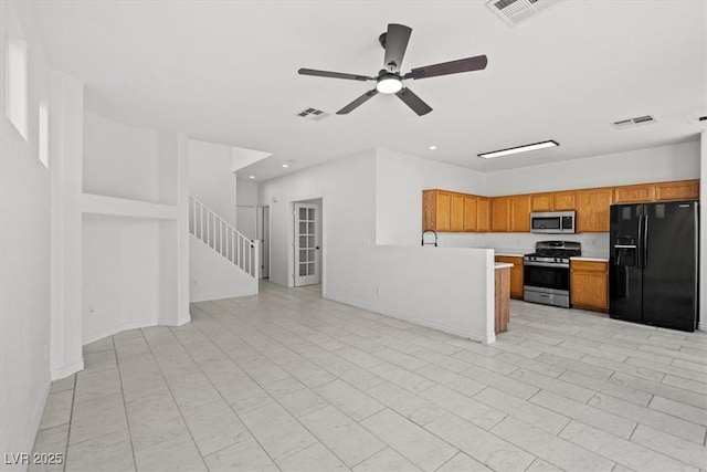 10642 Dawns Mist Ave, Las Vegas, NV 89129 - kitchen with appliances with stainless steel finishes, open floor plan, light countertops, brown cabinetry, and a ceiling fan