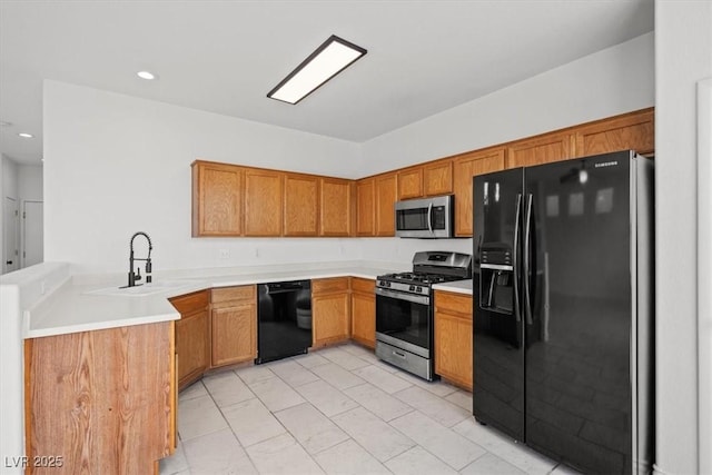 10642 Dawns Mist Ave, Las Vegas, NV 89129 - kitchen featuring black appliances, a sink, brown cabinetry, light countertops, and recessed lighting