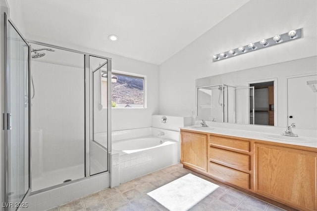 10642 Dawns Mist Ave, Las Vegas, NV 89129 - bathroom featuring a bath, vaulted ceiling, a stall shower, double vanity, and tile patterned floors