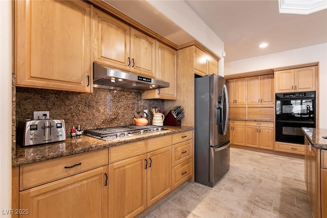 7718 Willow Cove Cir, Las Vegas, NV 89129 - kitchen with stainless steel appliances, under cabinet range hood, decorative backsplash, light brown cabinetry, and dark stone counters