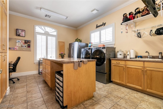 7718 Willow Cove Cir, Las Vegas, NV 89129 - washroom featuring washing machine and clothes dryer, crown molding, a sink, light tile patterned flooring, and an office area