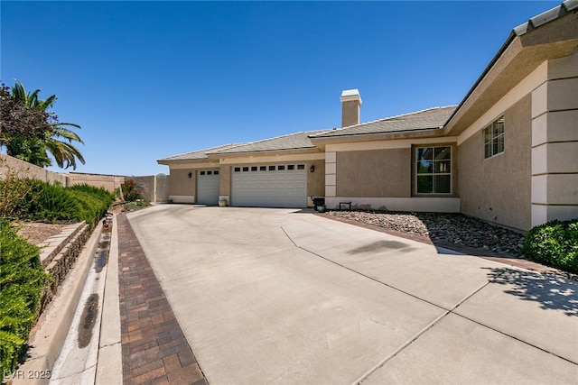 7718 Willow Cove Cir, Las Vegas, NV 89129 - view of front of property with a chimney, a garage, concrete driveway, and stucco siding