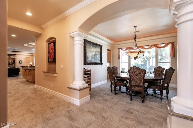 7718 Willow Cove Cir, Las Vegas, NV 89129 - dining room with decorative columns, crown molding, arched walkways, baseboards, and a chandelier