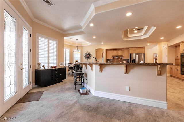 7718 Willow Cove Cir, Las Vegas, NV 89129 - kitchen featuring stainless steel refrigerator with ice dispenser, crown molding, a breakfast bar, a raised ceiling, and recessed lighting