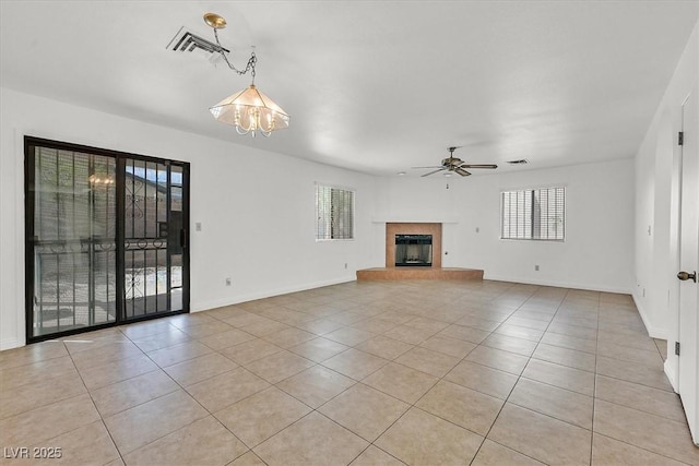 3935 Tirana Way, Las Vegas, NV 89103 - unfurnished living room featuring plenty of natural light, light tile patterned flooring, and a ceiling fan