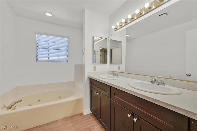 3935 Tirana Way, Las Vegas, NV 89103 - full bathroom featuring double vanity, a whirlpool tub, and wood finished floors