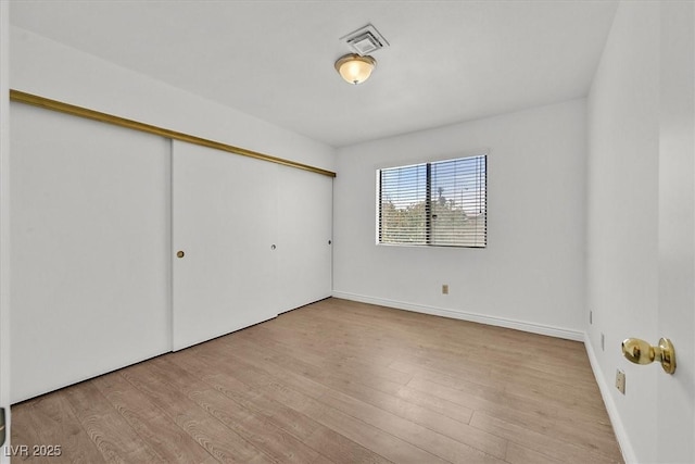 3935 Tirana Way, Las Vegas, NV 89103 - unfurnished bedroom with a closet, wood finished floors, and baseboards