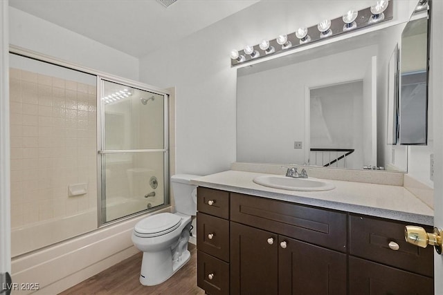 3935 Tirana Way, Las Vegas, NV 89103 - bathroom with vanity, toilet, wood finished floors, and combined bath / shower with glass door