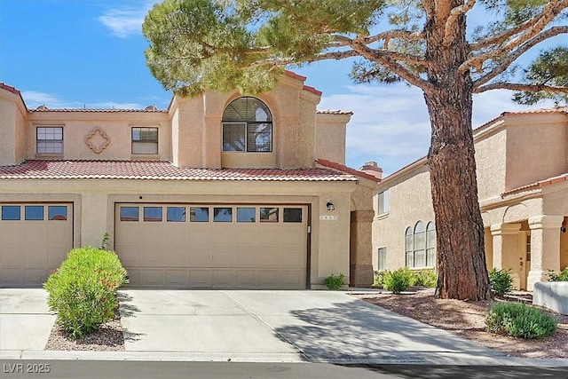 3935 Tirana Way, Las Vegas, NV 89103 - view of front facade featuring driveway, stucco siding, a tile roof, and an attached garage