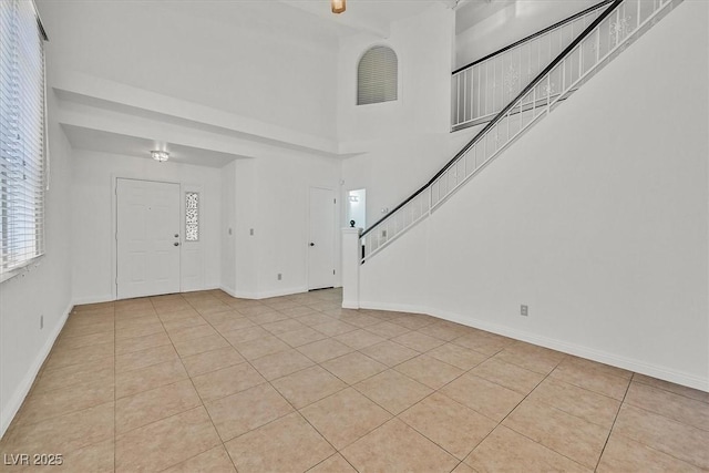 3935 Tirana Way, Las Vegas, NV 89103 - foyer featuring stairs, light tile patterned flooring, baseboards, and a high ceiling