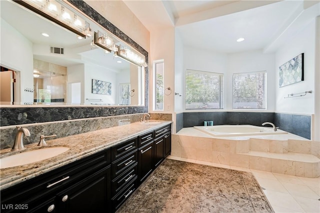 2231 S Tioga Way, Las Vegas, NV 89117 - bathroom featuring a garden tub, double vanity, tile patterned floors, a shower, and recessed lighting