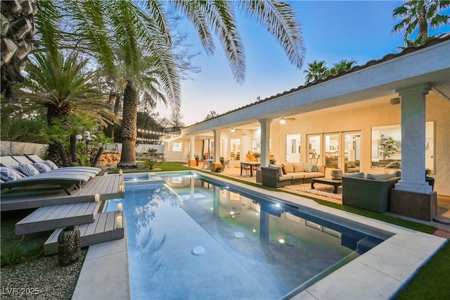 2231 S Tioga Way, Las Vegas, NV 89117 - pool at dusk with an outdoor hangout area, a ceiling fan, an outdoor hot tub, and an outdoor pool